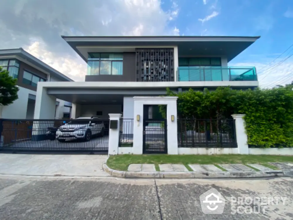 Modern two-story house with sleek design and spacious driveway in a serene neighborhood.