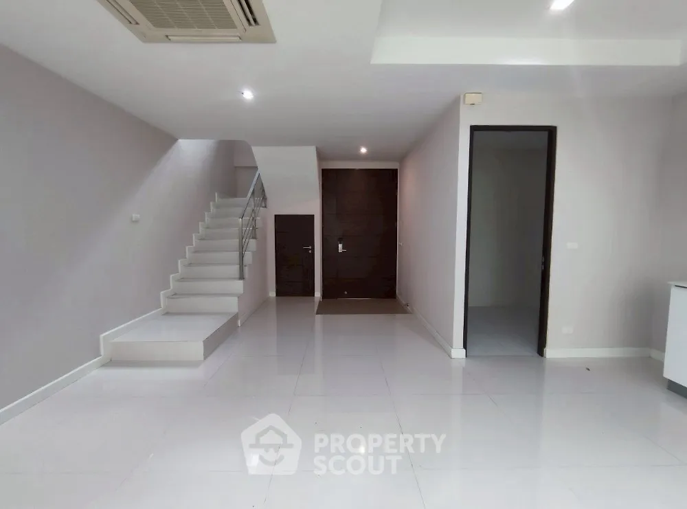Spacious modern interior with sleek staircase and minimalist design