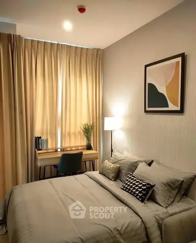 Cozy bedroom with modern decor, featuring a comfortable bed, stylish desk, and elegant lighting.