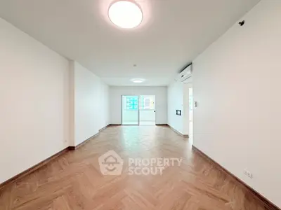 Spacious modern living room with wooden flooring and large windows