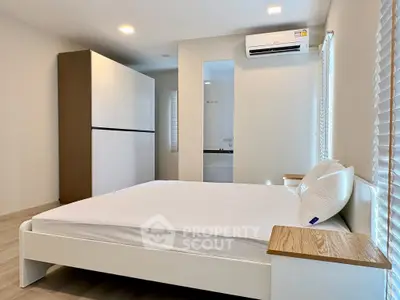Spacious modern bedroom with sleek design and natural light