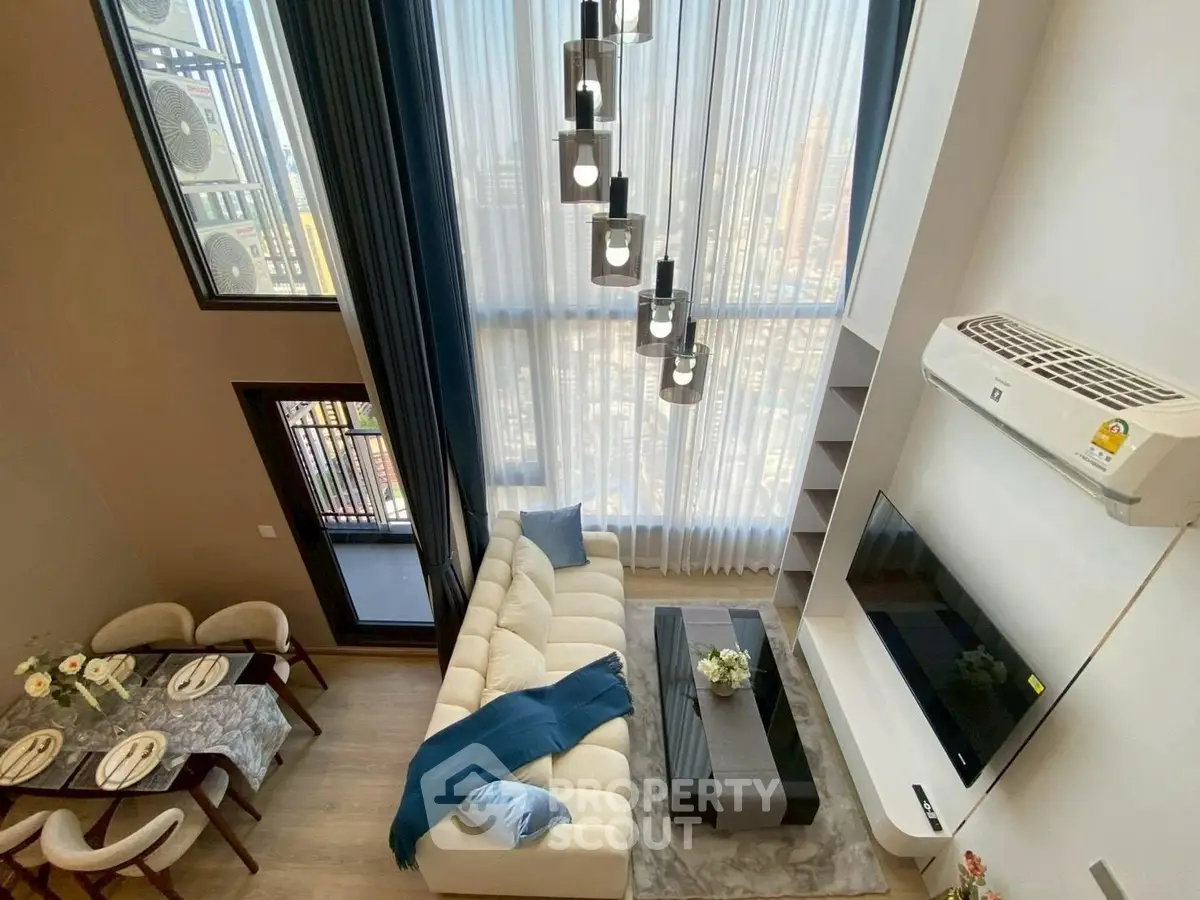 Luxurious high-ceiling living room with modern decor and stunning city view