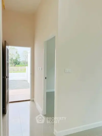 Bright and airy entrance hallway with open door leading to a scenic view, perfect for welcoming guests.