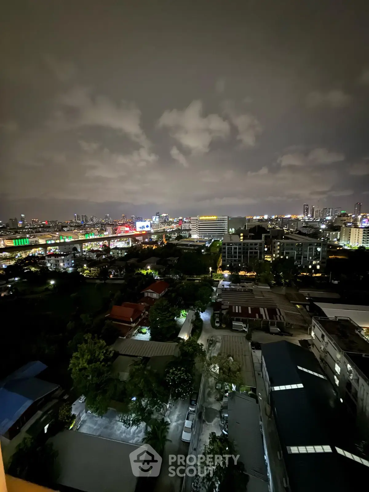 Stunning cityscape night view from high-rise apartment balcony