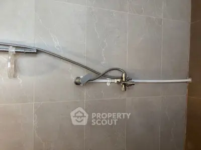 Modern bathroom shower fixture with sleek tile wall design