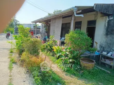 Charming rustic house with lush garden and outdoor patio in a serene neighborhood.