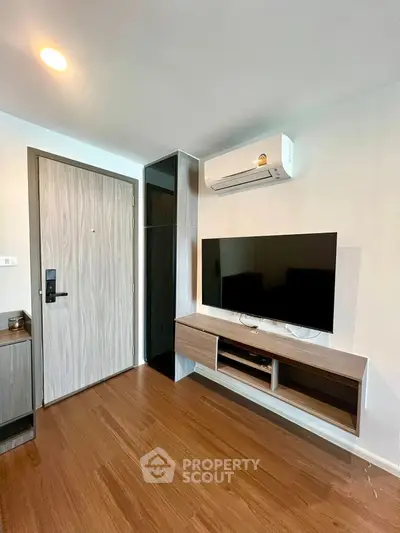 Modern living room with wall-mounted TV and air conditioning unit
