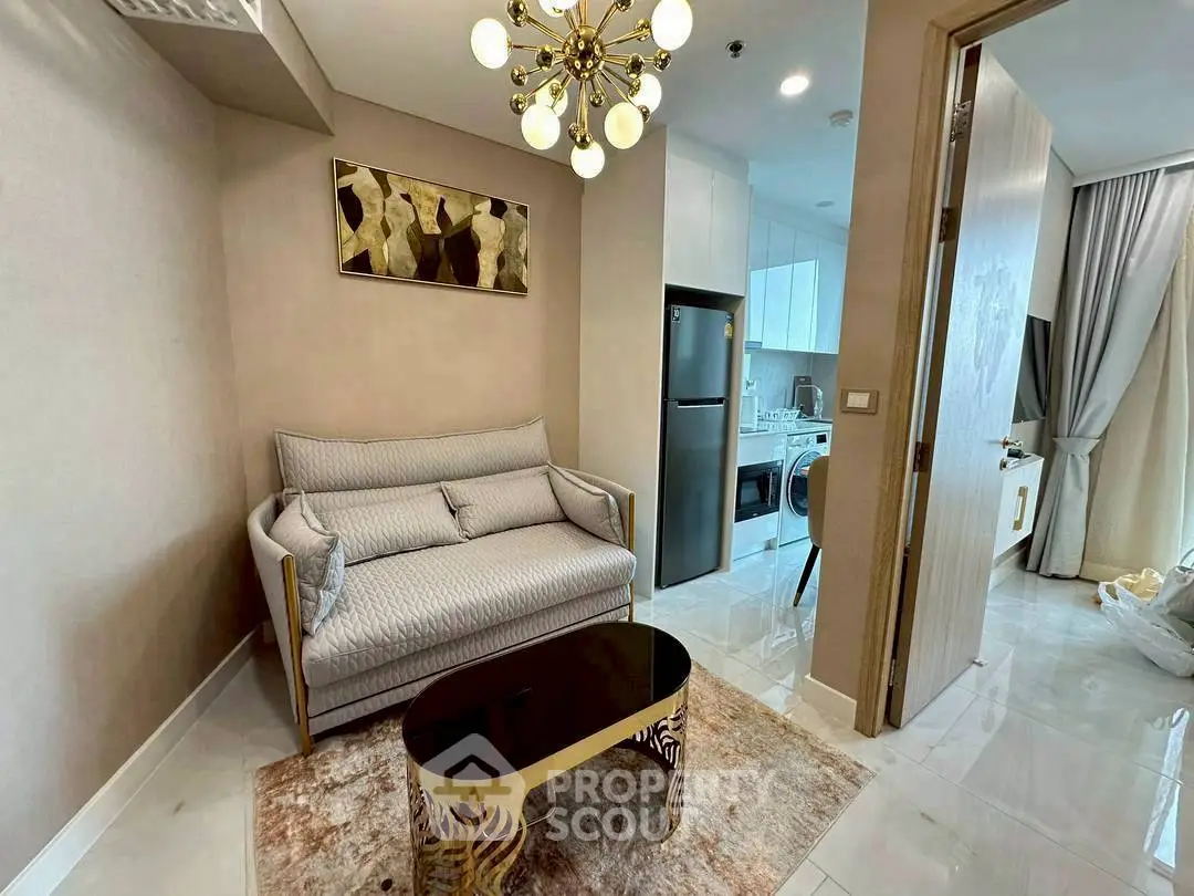 Modern living room with elegant decor and open kitchen layout in a stylish apartment.