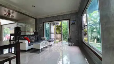 Spacious living room with modern decor and garden view