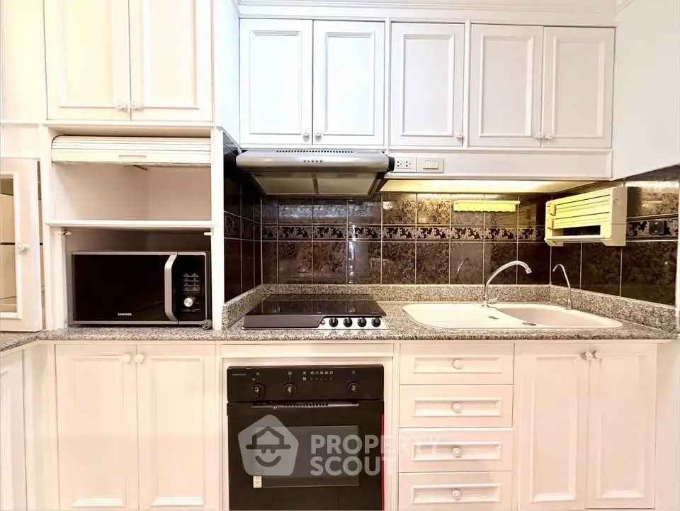 Modern kitchen with sleek appliances and elegant cabinetry