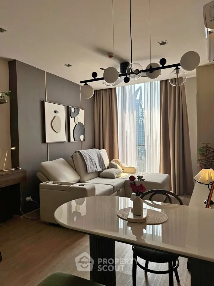 Modern living room with stylish decor and large window offering city view