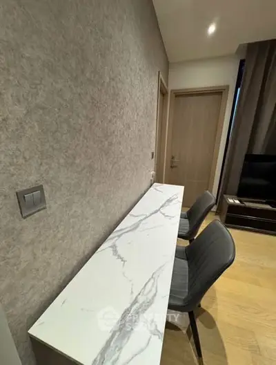 Modern interior with marble console and stylish chairs in a cozy living space.