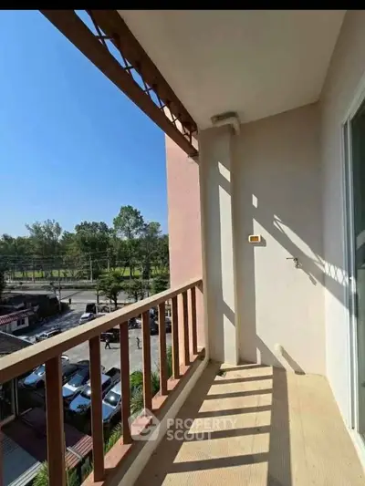 Spacious balcony with scenic view and natural light, perfect for relaxation.