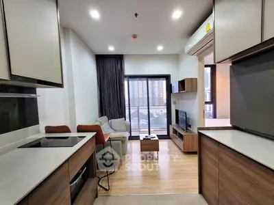 Modern open-layout living room with kitchen, featuring sleek design and city view.