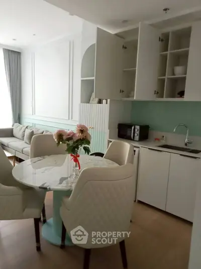 Modern open-layout kitchen and living area with elegant dining setup