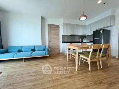 Modern open-plan living room with stylish kitchen and wooden flooring