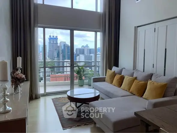 Luxurious living room with stunning city view and spacious balcony access.