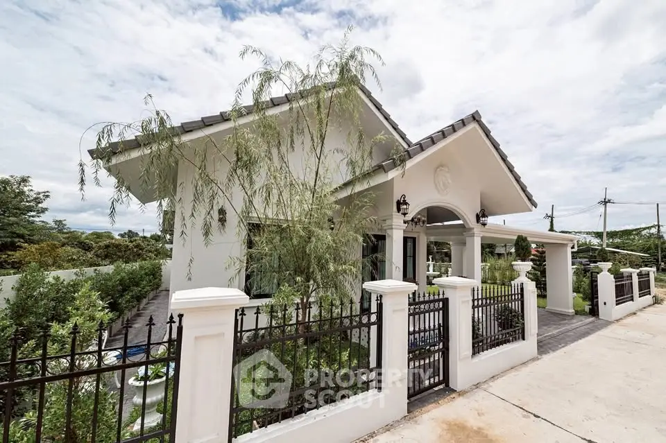Charming single-story house with lush garden and elegant fence