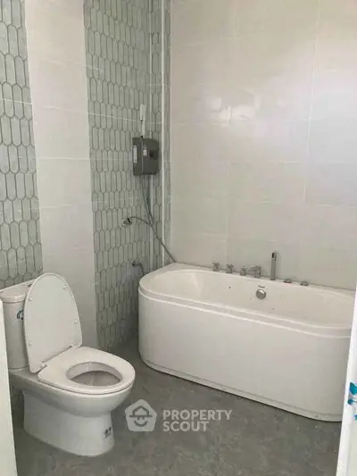 Modern bathroom with sleek bathtub and stylish tile design