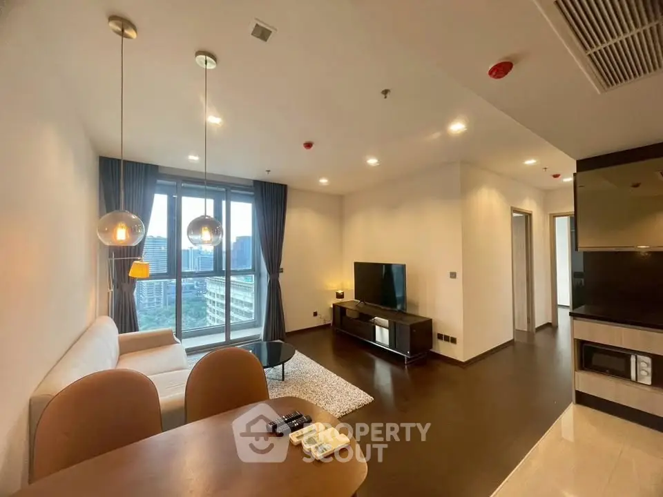 Modern living room with city view, stylish furniture, and elegant lighting