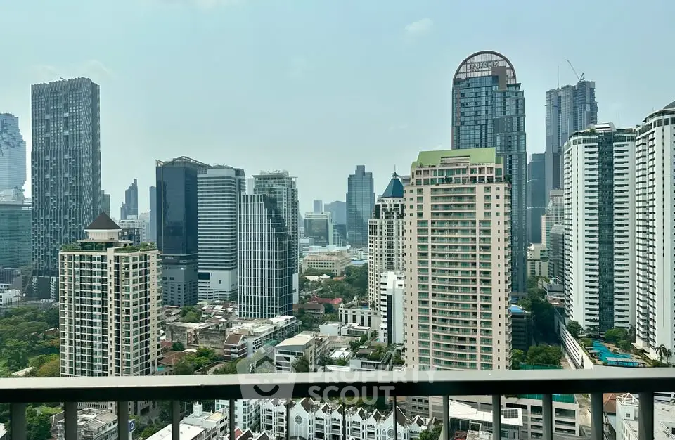Stunning cityscape view from a high-rise balcony showcasing modern skyscrapers and urban landscape.