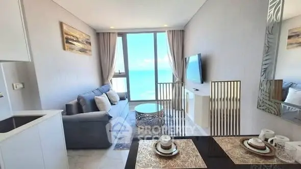 Modern living room with ocean view, stylish decor, and cozy seating area.