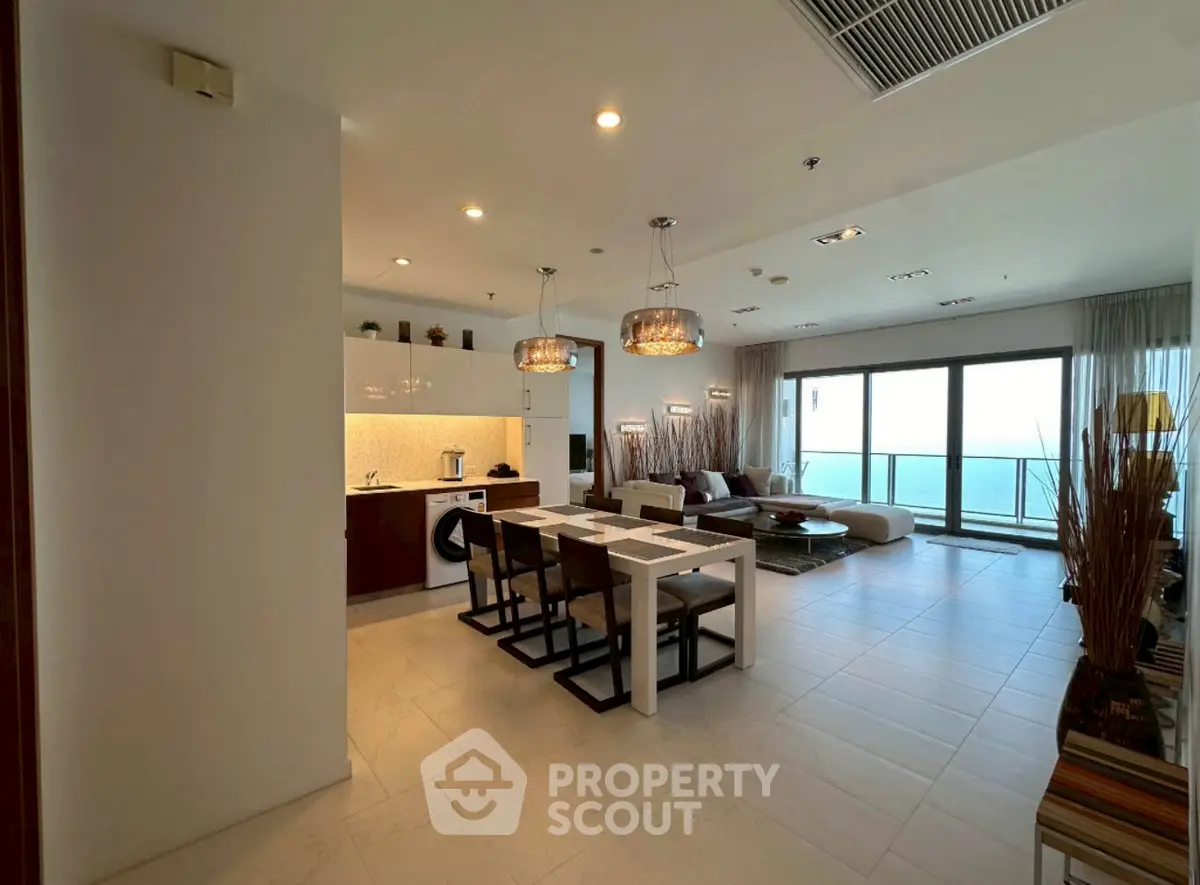 Luxurious open-plan living room with stunning sea view and modern kitchen