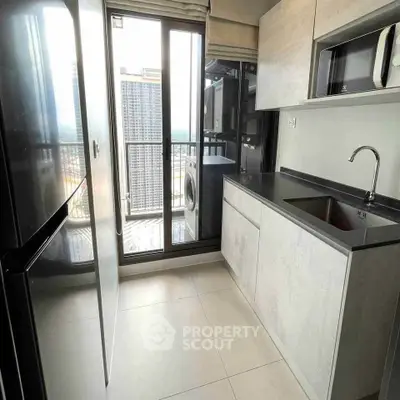 Modern kitchen with sleek cabinetry and balcony view in high-rise apartment