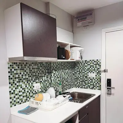 Modern kitchen with mosaic tile backsplash and sleek cabinetry