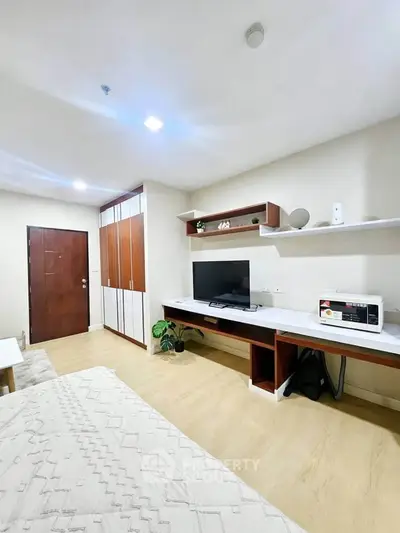 Modern bedroom with built-in wardrobe and sleek workspace