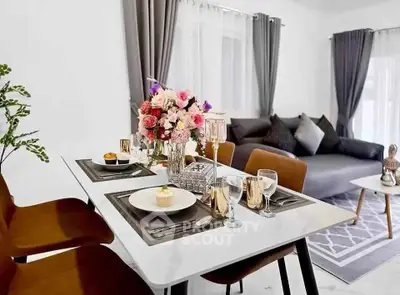 Elegant dining area with modern decor and cozy living room setup.