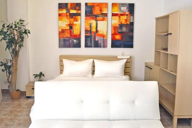 Modern bedroom with abstract art and stylish furniture