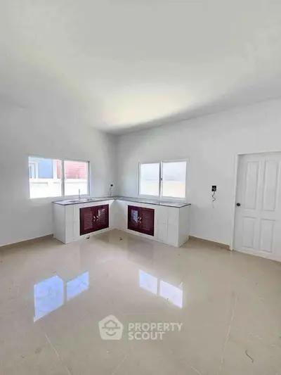 Spacious kitchen with modern cabinetry and ample natural light