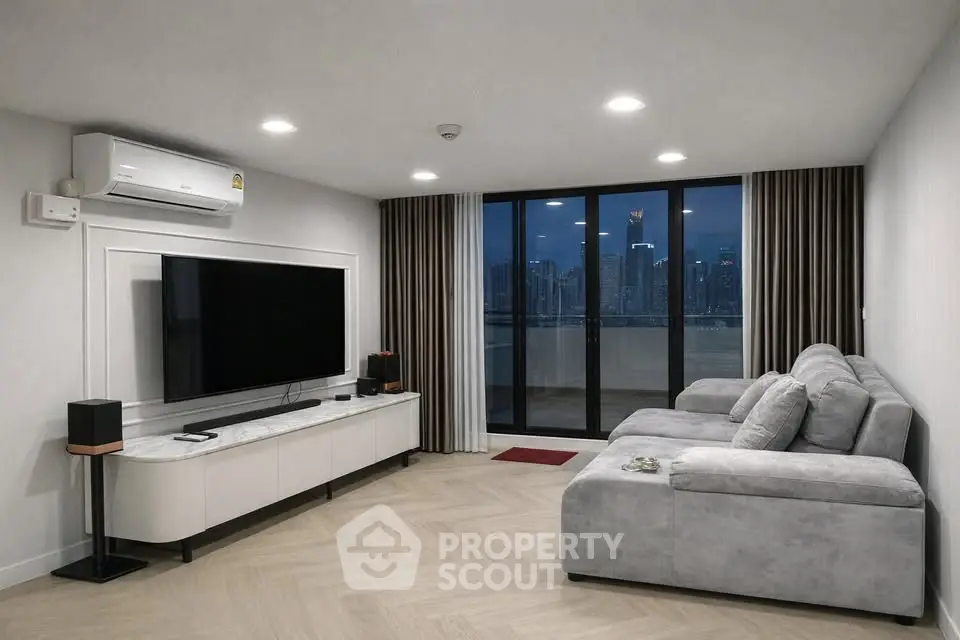 Modern living room with city view, featuring sleek furniture and large TV, perfect for urban living.