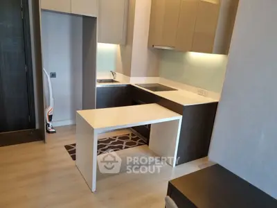 Modern kitchen with sleek cabinetry and integrated appliances in a compact layout.