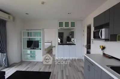 Modern open-plan living room with sleek kitchen and stylish decor