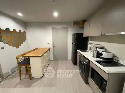 Modern kitchen with sleek appliances and stylish decor in a contemporary apartment.