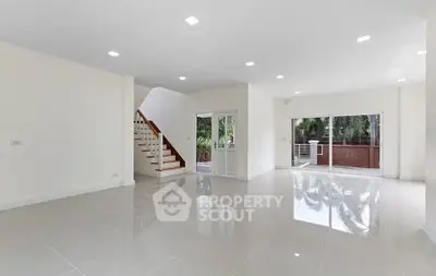 Spacious modern living room with glossy tiles and large windows