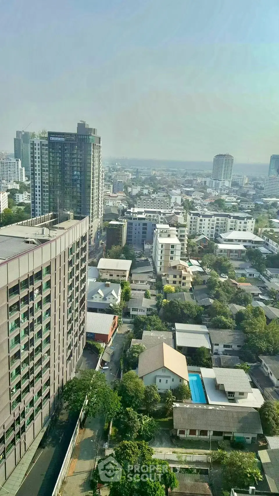 Stunning aerial view of urban skyline with modern high-rise buildings and lush greenery, perfect for city living.