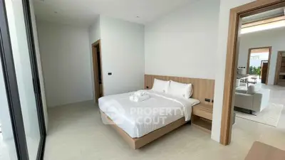Modern bedroom with minimalist design and large windows in luxury real estate property.