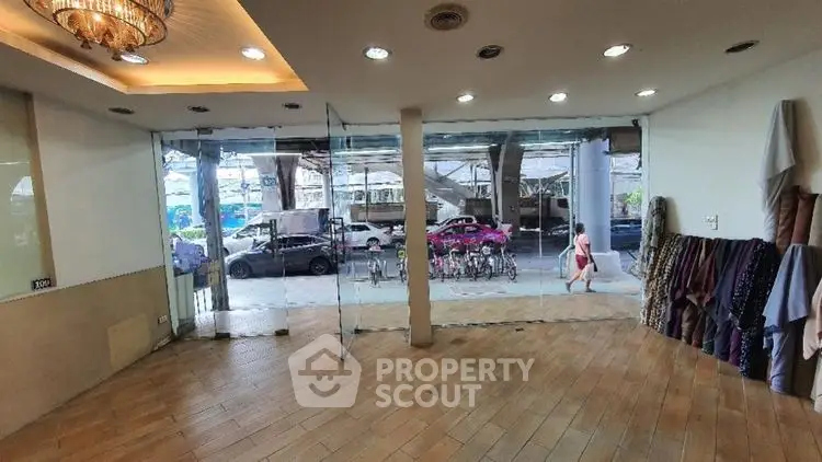 Spacious commercial space with glass doors and street view, ideal for retail or office use.