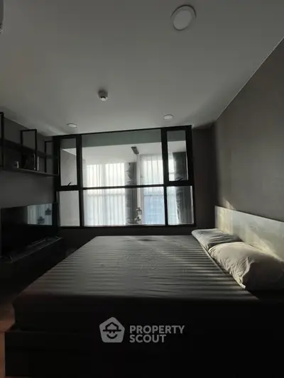 Modern bedroom with large window and minimalist design