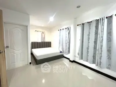 Spacious bedroom with modern design and ample natural light