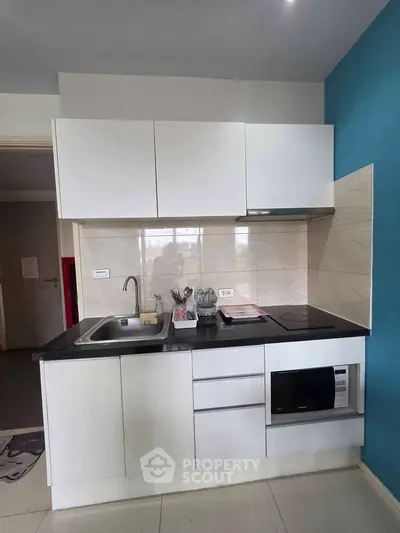 Modern kitchen with sleek cabinetry and built-in appliances in a stylish apartment.