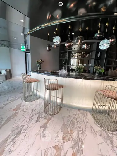 Luxurious modern bar area with elegant marble flooring and stylish seating in upscale property.