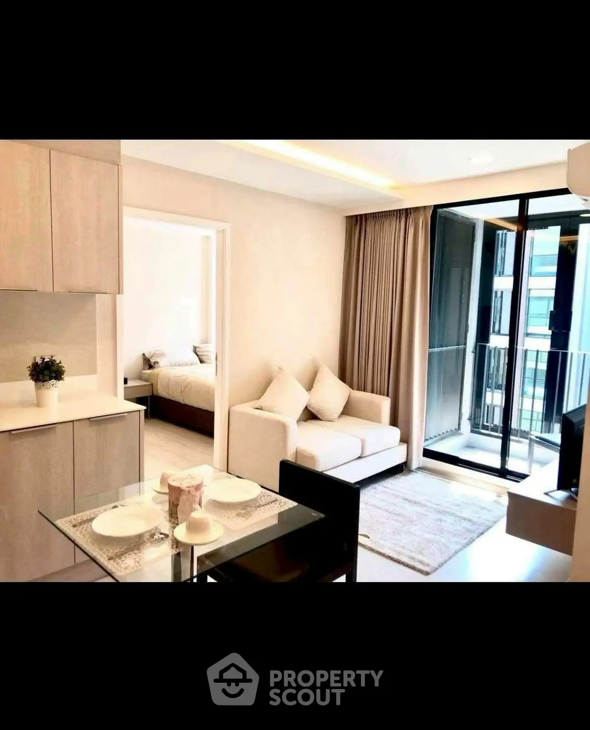 Modern apartment with open layout, cozy living area, and balcony access.