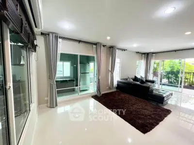 Spacious modern living room with large windows and balcony access