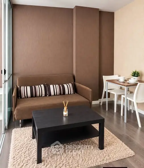 Modern living room with cozy sofa, stylish coffee table, and dining area in a chic apartment.