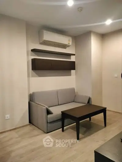 Modern living room with sleek furniture and air conditioning in a stylish apartment.
