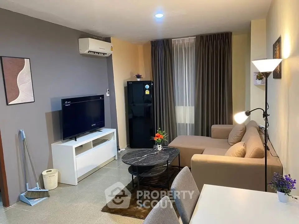 Modern living room with stylish decor, featuring a cozy sofa, flat-screen TV, and elegant lighting.